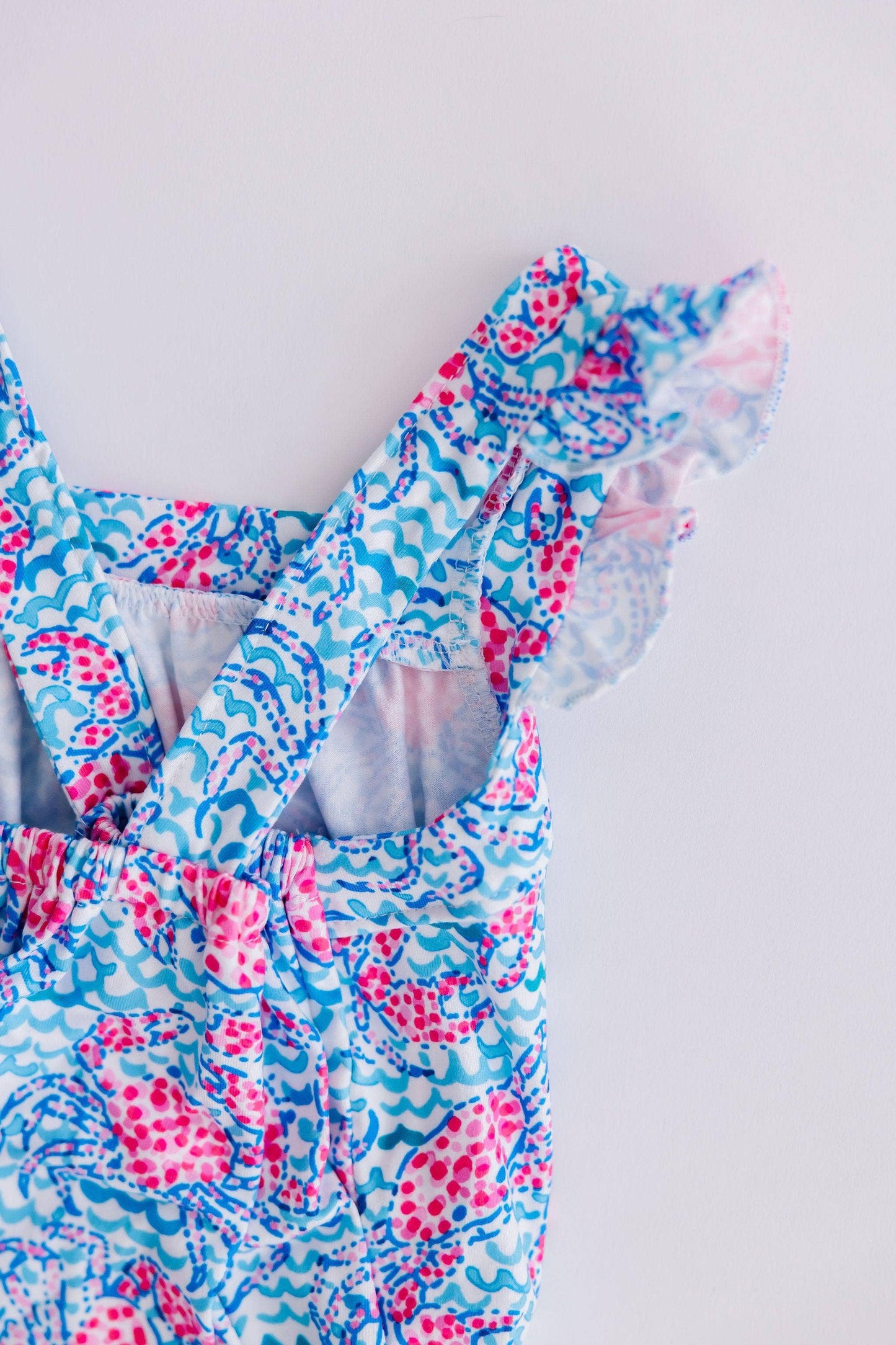 Crab Walk Ruffle Cross Back Romper